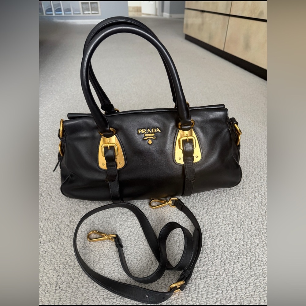 Authentic Prada Black leather and Gold hardware bag in prestine condition.